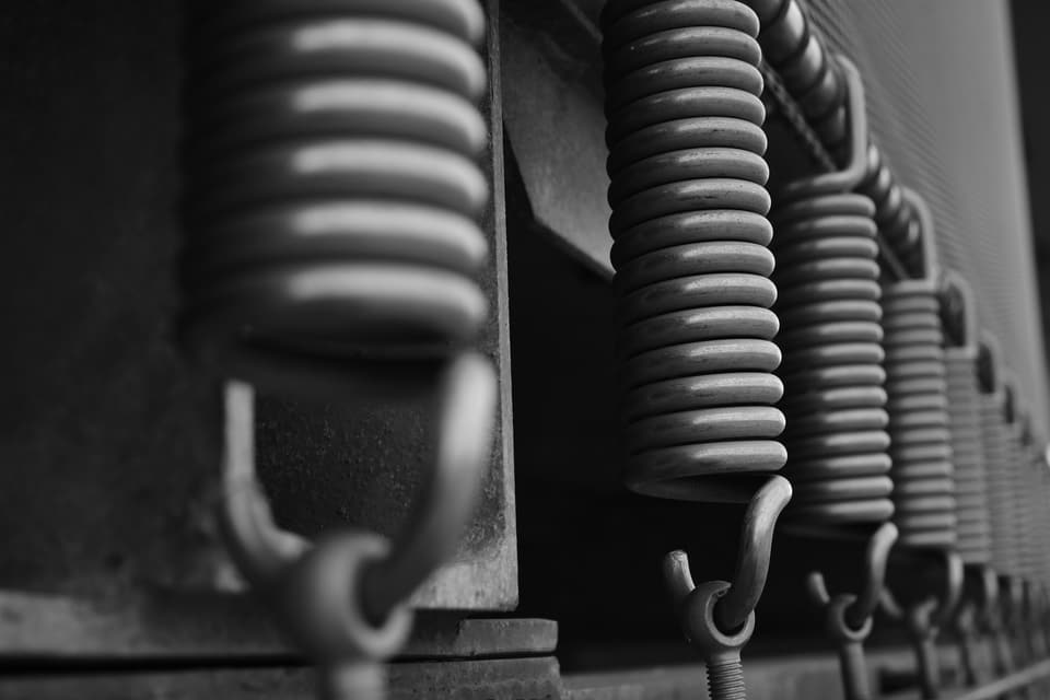 A row of coiled steel extension springs