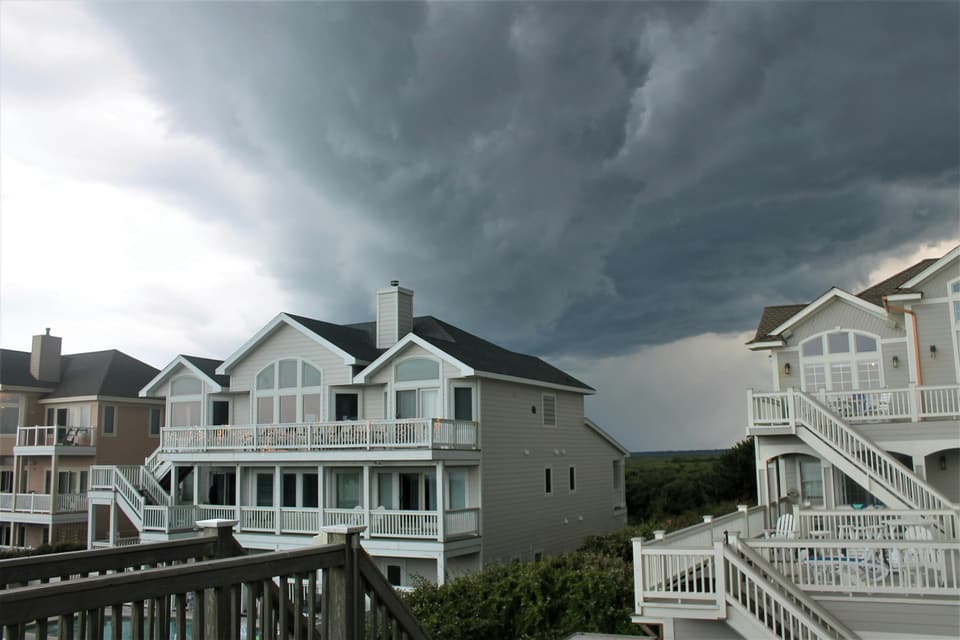 Dark storm clouds over a row of houses